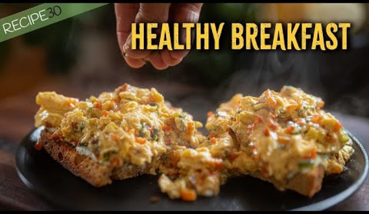 Scrambled Eggs with Vegetables on Sourdough Toast with Greek Yogurt and Seeds.