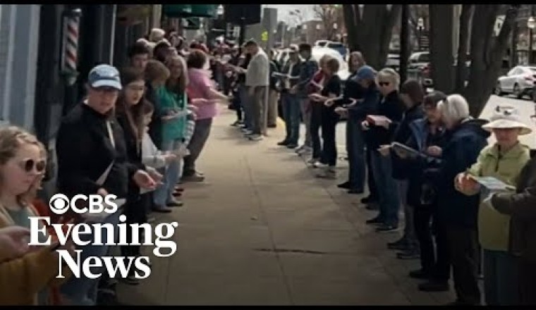 Hundreds Form a Human Chain To Move a Michigan Bookstore by Hand